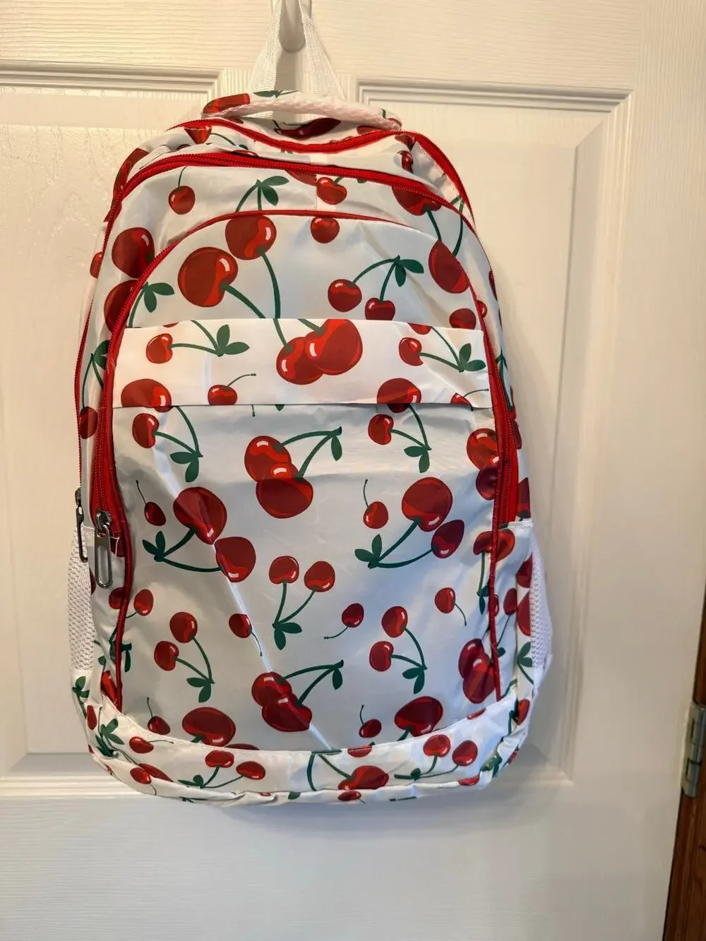 New white backpack cherry pattern.Padded back,multiple pockets,adjustable straps